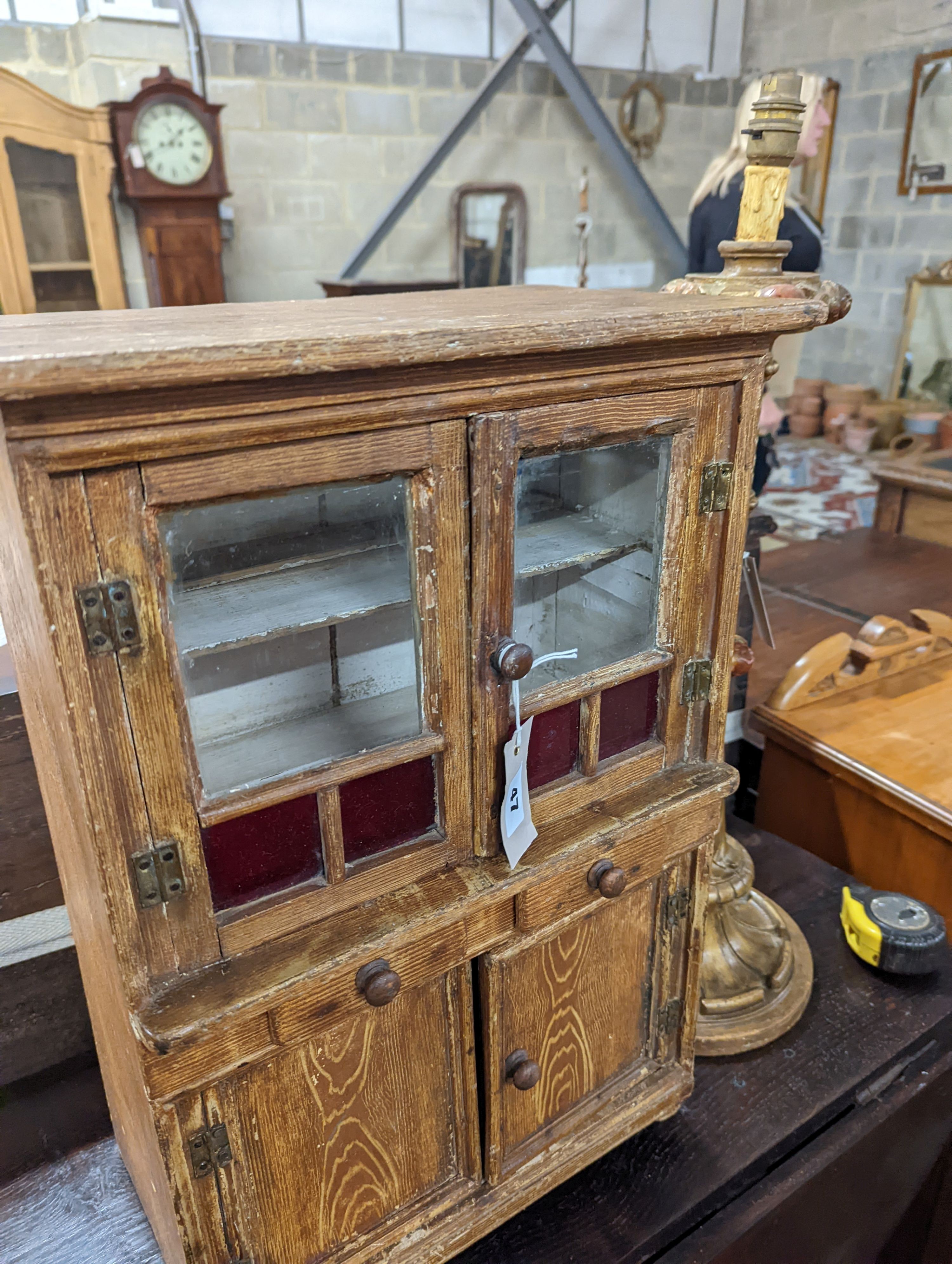 A 19th century Continental grained pine miniature dresser, width 39cm, depth 24cm, height 56cm